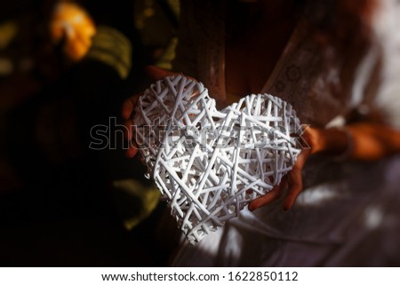 Woman and white heart in your hand.