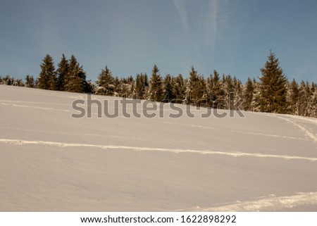 Beautiful winter landscape in the Czech Ore Mountains on the Klinovec mountain in the sunshine