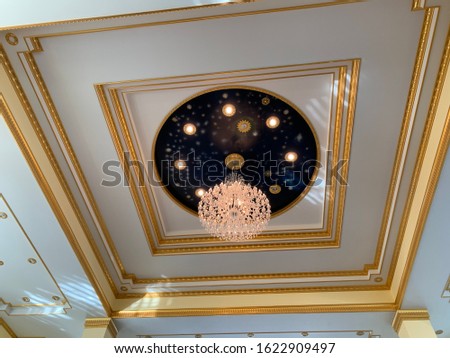 Chandelier on the ceiling with gold and white