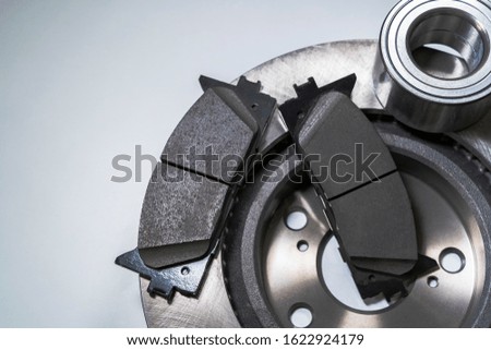 brake pads and auto parts on a white table