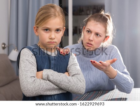 Serious adult mother scolding her teenage daughter at home Royalty-Free Stock Photo #1622929693