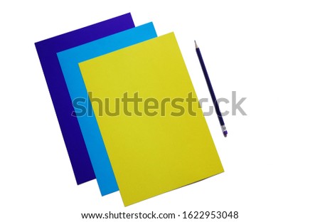 blue, cyan and yellow sheets of paper and pencil, copy space