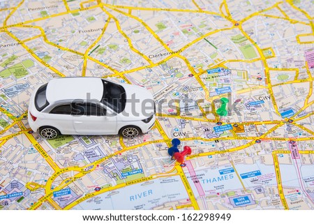 Image of travel concept. small car on London city map