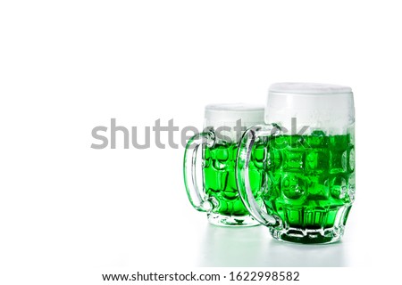 Traditional St Patrick's Day green beers isolated on white background. Copy space