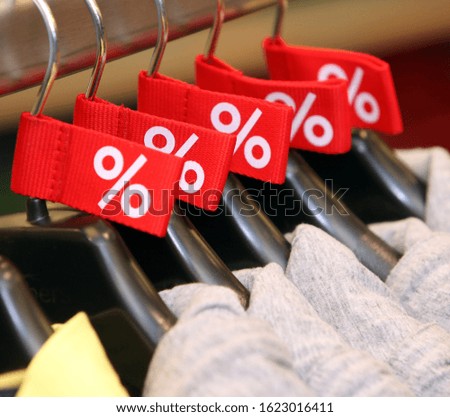Red sale tags on clothes hanger