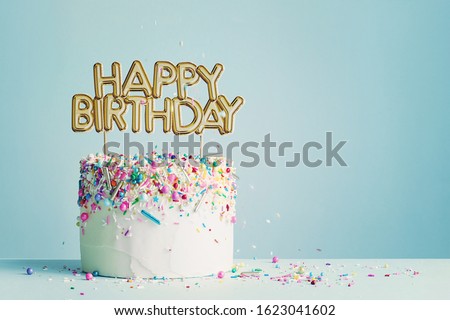 Birthday cake with gold happy birthday banner Royalty-Free Stock Photo #1623041602
