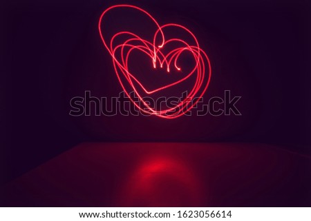 Red hearts on a black background for your valentine, long exposure photography, isolated
