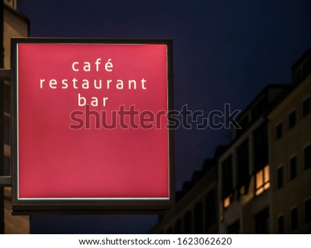 Cafe, restaurant, bar  neon red or pink sign. Bright sign at night. neon at night. Blank Lightbox Signage hang on wall. night city life.