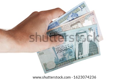 Jordanian money with hand on white background  Royalty-Free Stock Photo #1623074236