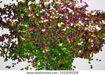three colors green, gold and purple. Traditional of Mardi Gras festive. glitter sequins of Mardi Gras celebration color background texture bokeh