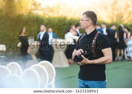 photographer working at event at yard of restaurant