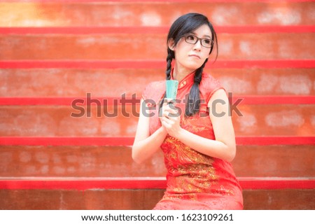 Asian beautiful woman photographed in Chinese national costumes for the Chinese New Year event