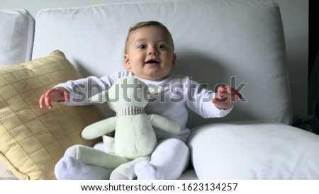 
Happy smiling baby toddler infant laid in changing room