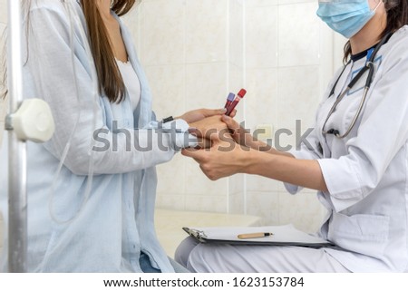 Doctor holding patient's hands in her hands, close up