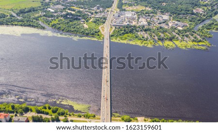 Aerial view photo from flying drone panoramic of the Southern bridge (Dienvidu tilts) on the river Daugava and Riga city background in Riga, Latvia. (series)