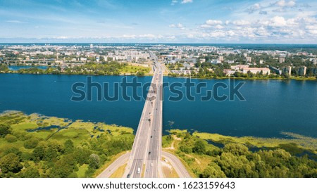 Aerial view photo from flying drone panoramic of the Southern bridge (Dienvidu tilts) on the river Daugava and Riga city background in Riga, Latvia. (series)