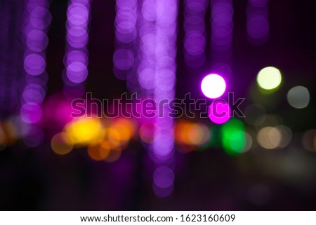 Bokeh light background of beautiful party at night. Pink and purple bokeh.