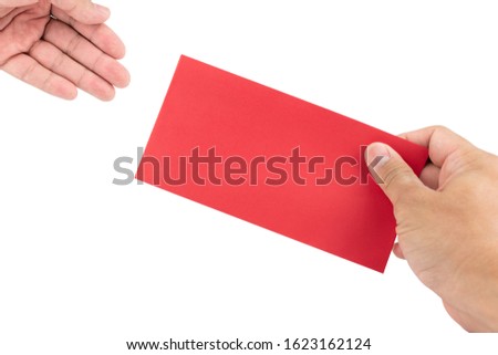 The hand is holding the chinese red envelope for the person on a white background