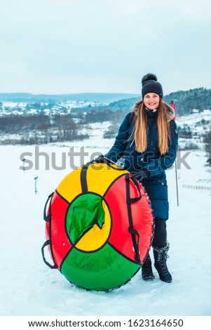 laughing woman on snowing tube
