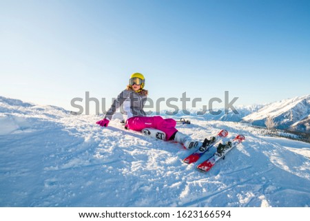 Happy children with helmet and goggles on the ski slopes