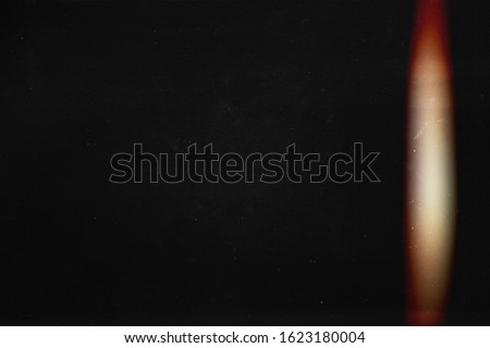 Black abstract background. Light effect. Instant photo. redacted. Foto film effect.  Lens flare and heavy grain. 70s Royalty-Free Stock Photo #1623180004
