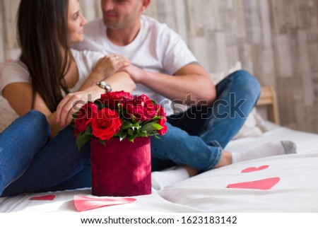 Happy young couple celebrating Valentine's Day at home
