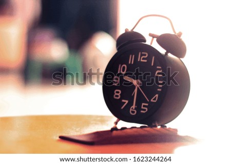 Black alarm clock on Yellow guitar background