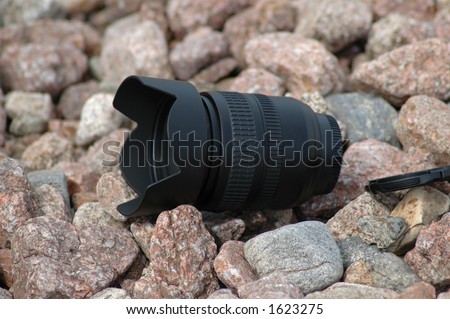 Camera lens on pebbles