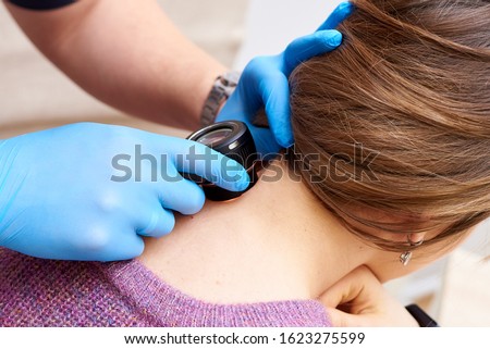 A safe way to diagnose skin diseases. Examination of moles and other skin lesions.Prevention of dangerous skin illness. Royalty-Free Stock Photo #1623275599