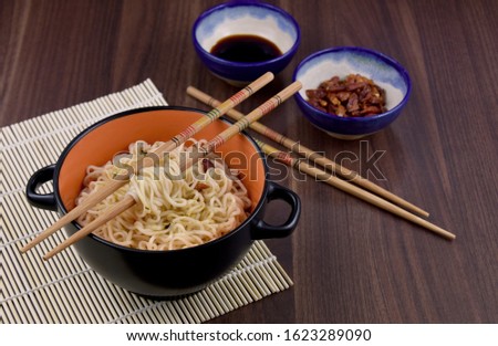Chinese noodles in bowl stock images. Chinese noodles still life. A bowl of chinese noodles with chopstick stock images