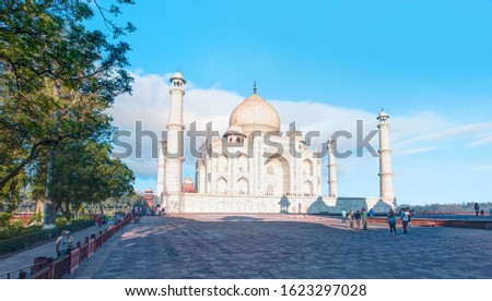 Unidentified people walk around Taj Mahal. Taj Mahal was designated as a UNESCO World Heritage Site in 1983.