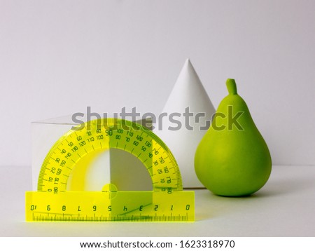 geometric shapes, cone with cube, protractor, toy pear