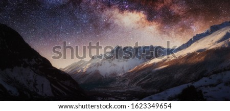 Milky Way above snowy mountains. Sky with stars at night in Nepal, Himalayas.