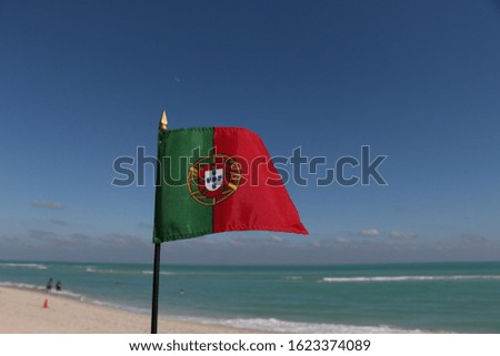 Beautiful National Flag of Portugal on Tropical Beach