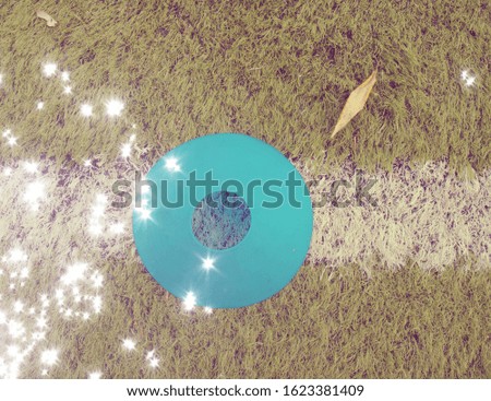 Abstract filtered football field - white soccer net and players on the background