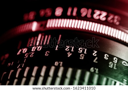 Scale of the photo lens. The black lens is made of metal and plastic. Shallow depth of field.