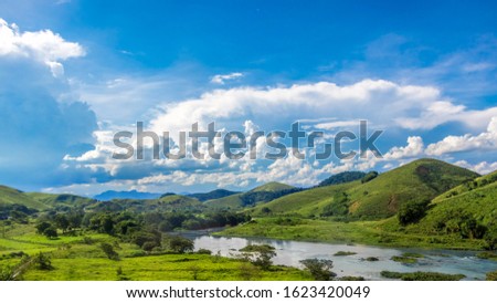 Beauty in Nature Summer Landscape. Aerial View in Rio de Janeiro District. Rainforest Mountains, Green Grass , Blue Sky with Beautiful Clouds, Clean River. Amazing Hiking Place. 