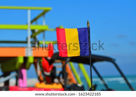 Beautiful National Flag of Romania on Tropical Beach