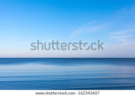 Blue sky over blue Baltic sea. Royalty-Free Stock Photo #162343607