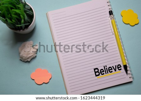 Believe write on a book isolated on office desk. Christian faith concept