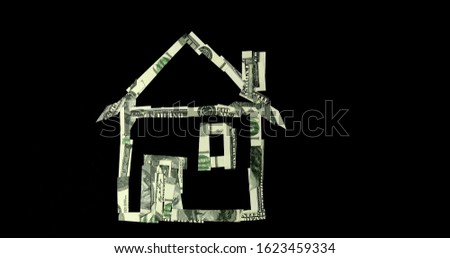 Pieces of dollar banknotes form a house. Real estate investment concept.