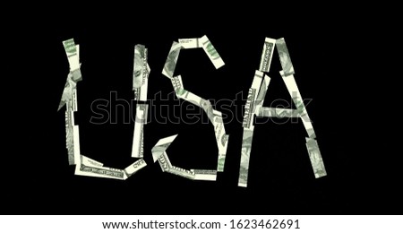 Pieces of dollar banknotes form the word USA. US Currency Investment Concept.