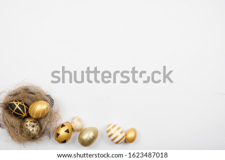 Easter golden decorated eggs in nest isolated on white background for web banner. Minimal easter concept. Happy Easter card with copy space for text. Top view, flatlay.