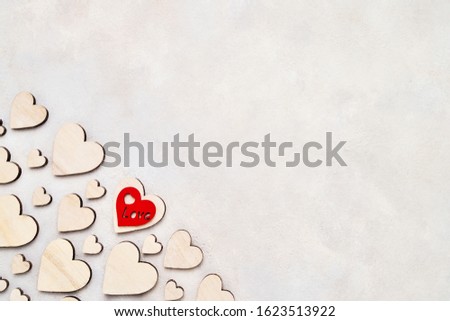 Valentines Day background. Wooden hearts on a concrete background, top view. Valentines Day concept. Copy space for text, top view.