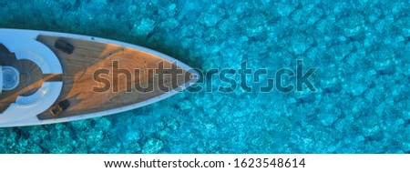 Aerial drone ultra wide photo of mega yacht nose docked in tropical exotic island bay with turquoise clear sea Royalty-Free Stock Photo #1623548614