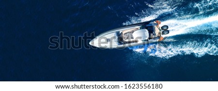Aerial drone top down ultra wide photo with copy space of inflatable speed boat with wooden deck cruising in high speed in deep blue Aegean sea Royalty-Free Stock Photo #1623556180