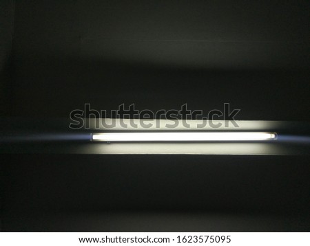 Dim light, fluorescent lamp on the background room ceiling.