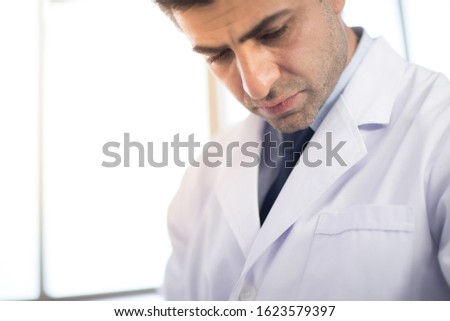Portrait, A male doctor wearing a white coat in the hospital