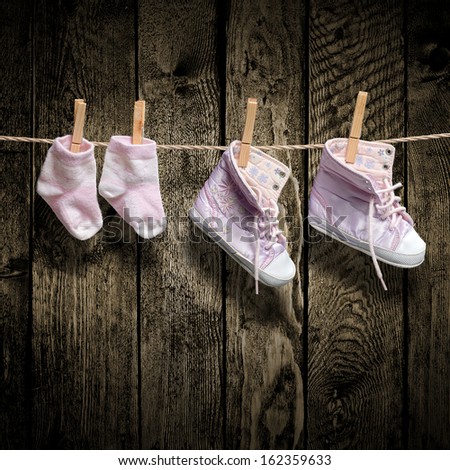 Baby girl shoes and socks on the clothesline