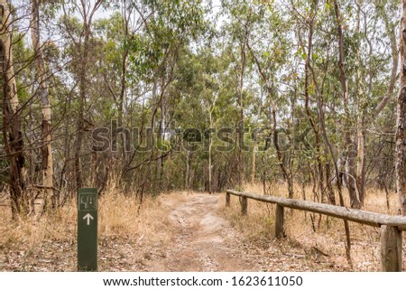 Directional sign a dusty path through Eucalyptus Trees - Adelaide, South Australia